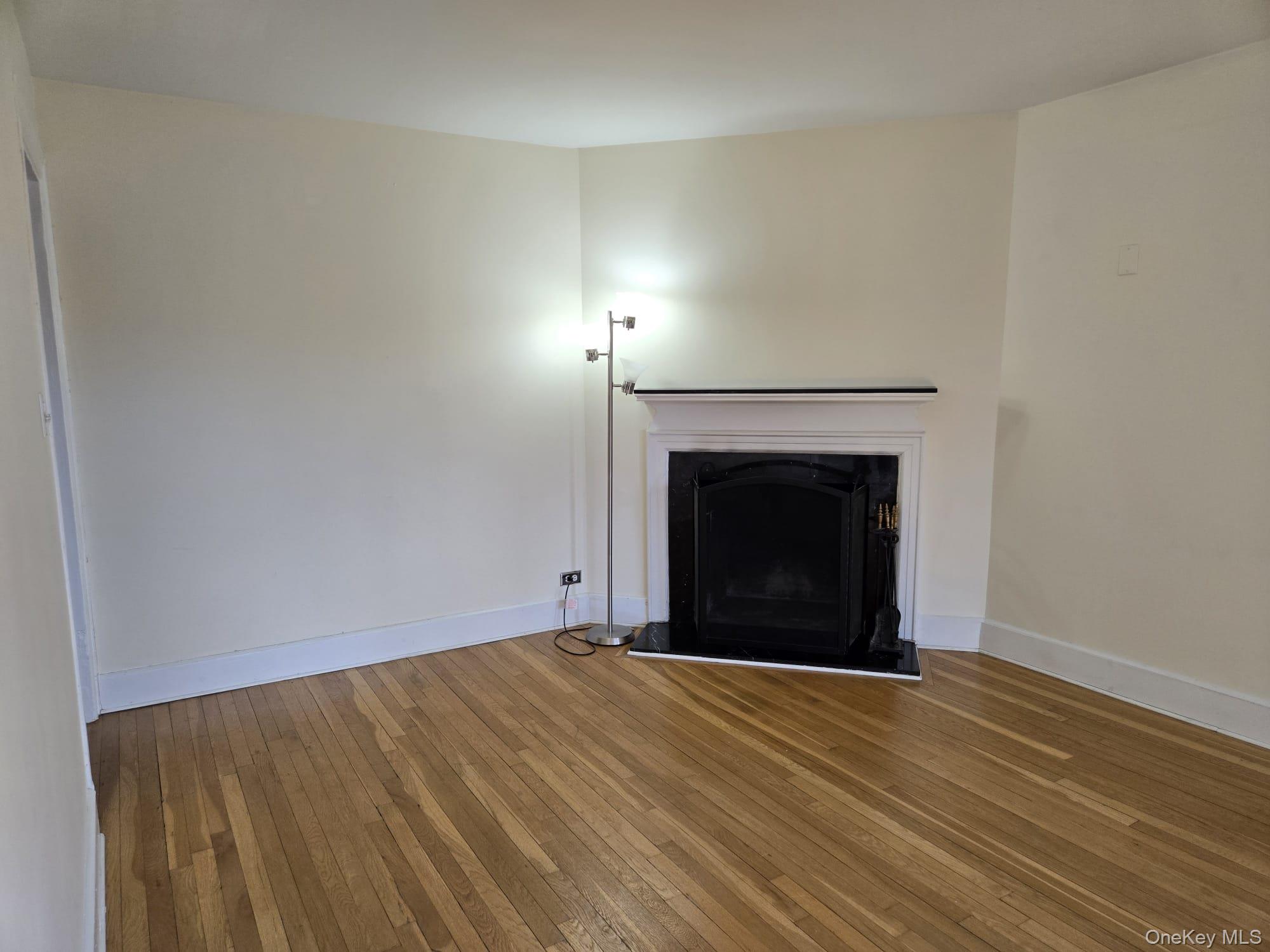 6 Davis Avenue, Unit A11 Rye, NY 10580 - Photo 5 of 23 Living room with fireplace.
