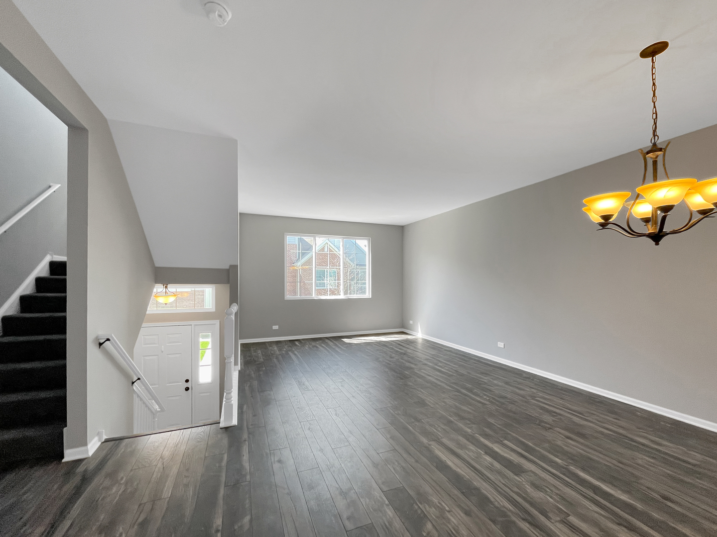 3414 Cameron Drive Elgin, IL 60124 - Photo 7 of 24 an empty room with wooden floor and windows