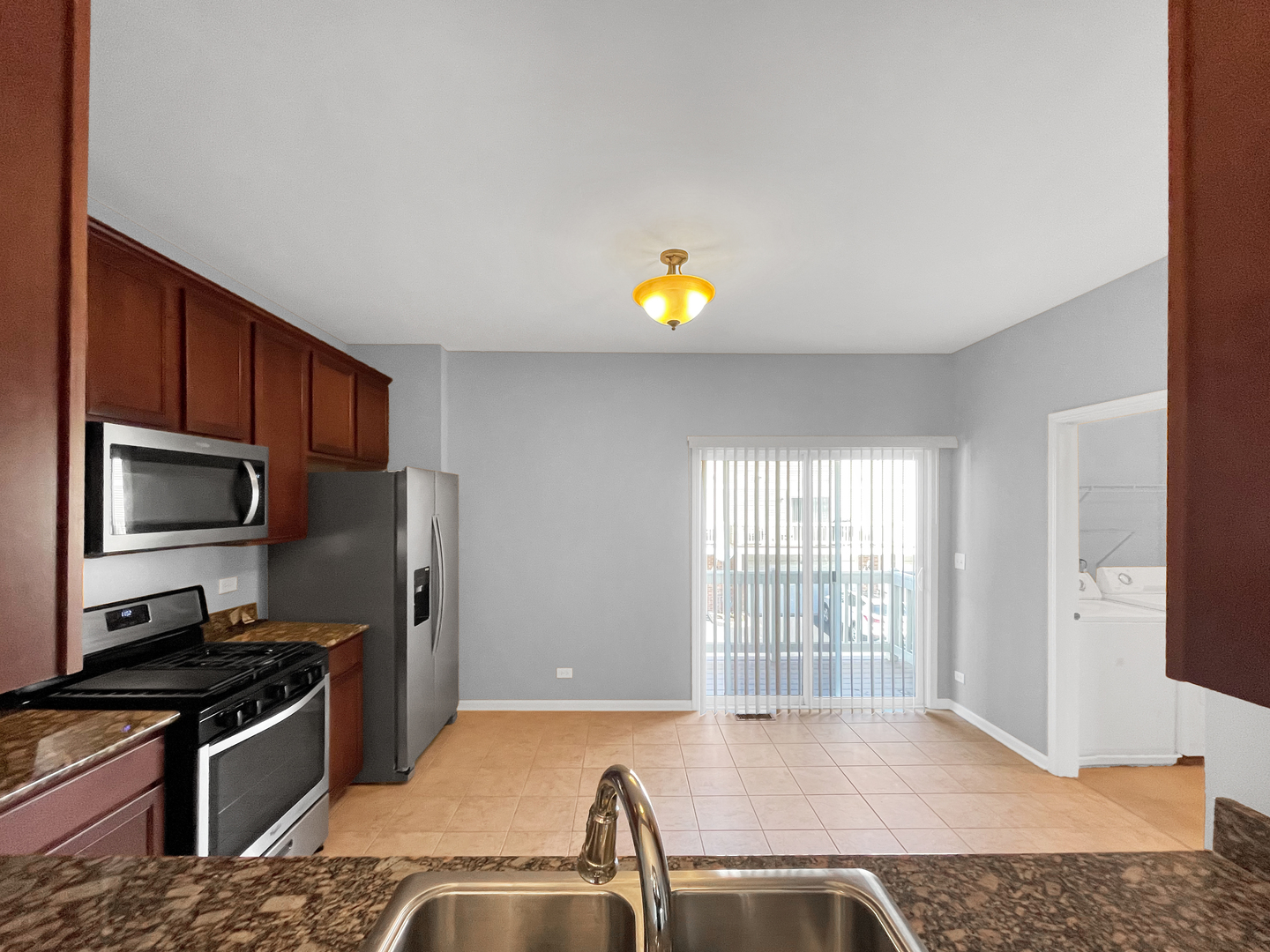 3414 Cameron Drive Elgin, IL 60124 - Photo 10 of 24 a kitchen with a sink a counter top space cabinets stainless steel appliances and a window