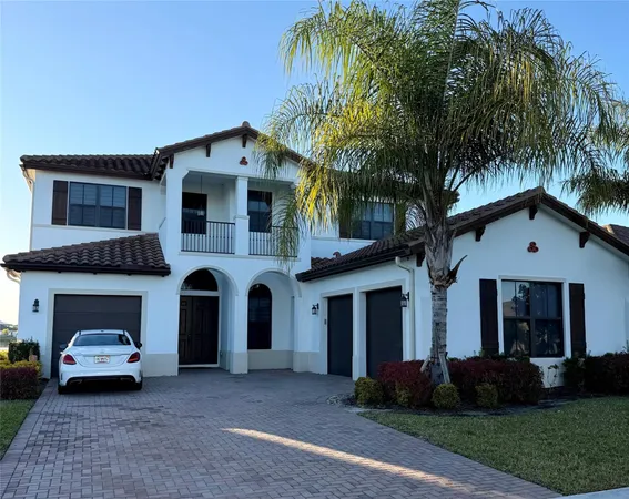 a front view of a house with a garden and trees
