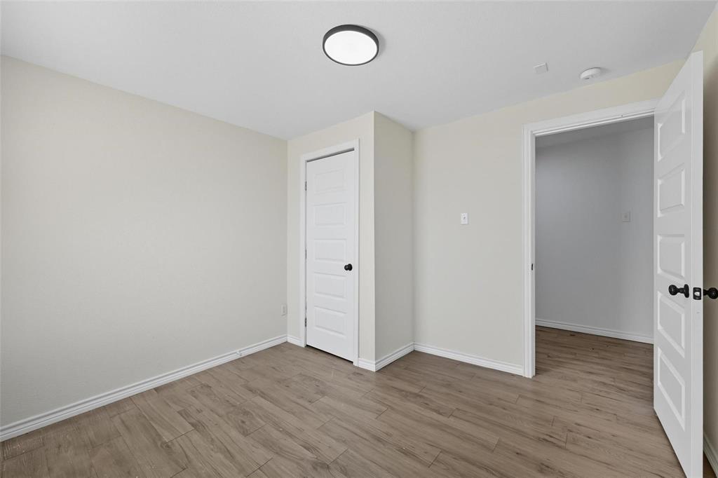 622 South Charles Street, Unit 622 Sherman, TX 75090 - Photo 11 of 21 a view of an empty room with wooden floor and a window