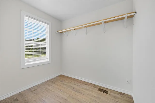 a view of a room with wooden floor and fan