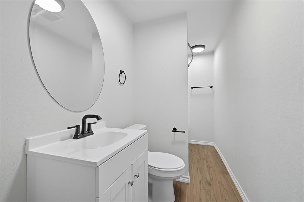 622 South Charles Street, Unit 622 Sherman, TX 75090 - Photo 13 of 21 a bathroom with a sink a toilet and a mirror