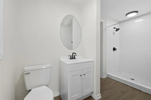 a bathroom with a toilet a sink and mirror