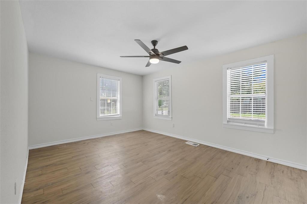 622 South Charles Street, Unit 622 Sherman, TX 75090 - Photo 8 of 21 an empty room with wooden floor and windows
