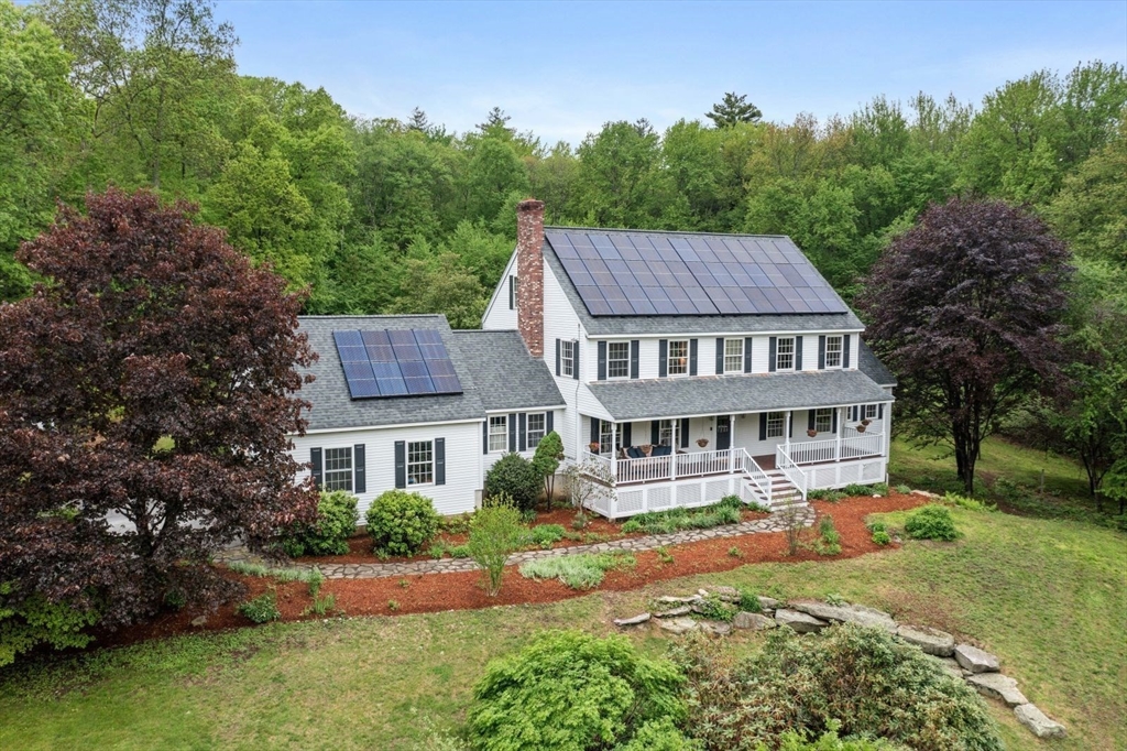 176 Spring Street Hopkinton, MA 01748 - Photo 2 of 42 a aerial view of a house with a yard table and chairs