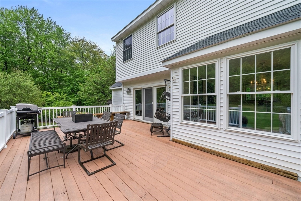 176 Spring Street Hopkinton, MA 01748 - Photo 21 of 42 a view of a deck with table and chairs and wooden floor