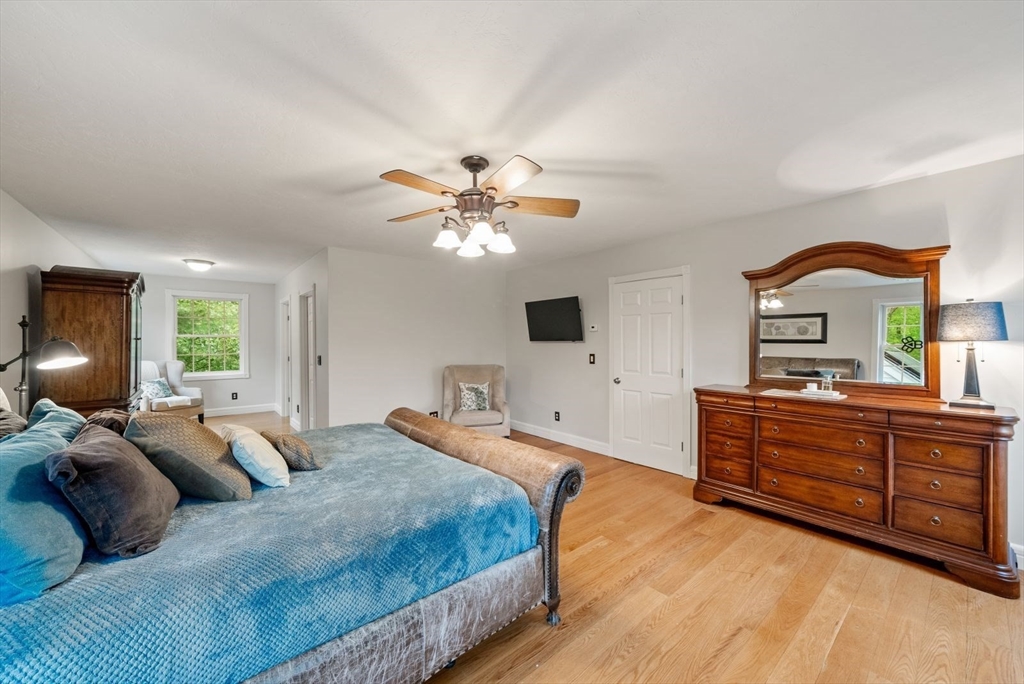 176 Spring Street Hopkinton, MA 01748 - Photo 29 of 42 a bed room with a bed and a chandelier