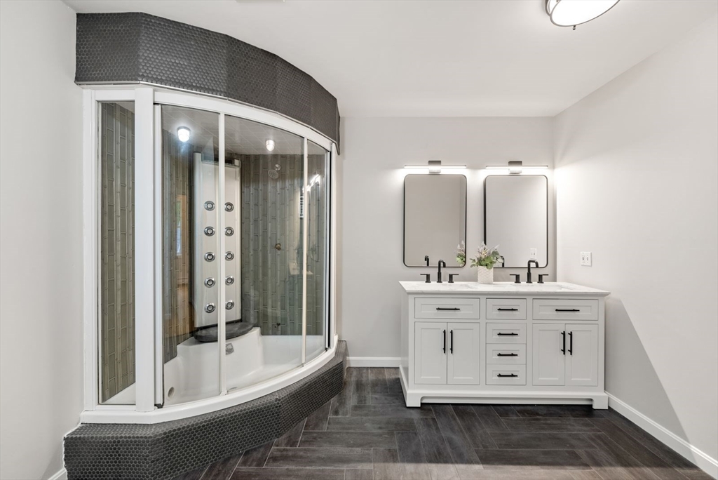 176 Spring Street Hopkinton, MA 01748 - Photo 30 of 42 a bathroom with a double vanity sink and mirror