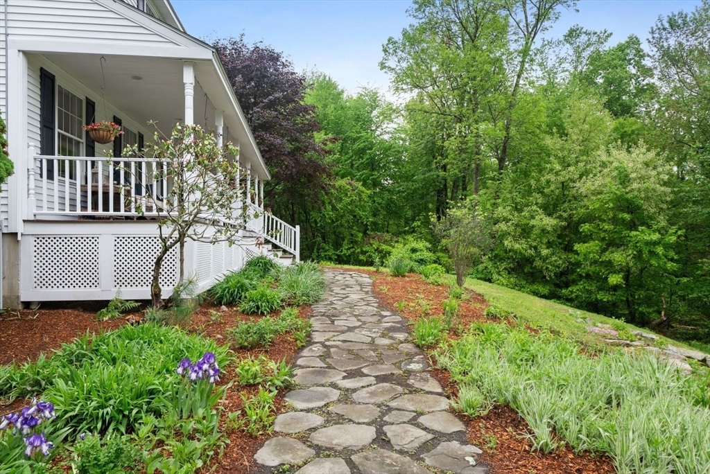 176 Spring Street Hopkinton, MA 01748 - Photo 3 of 42 a view of a pathway with a garden