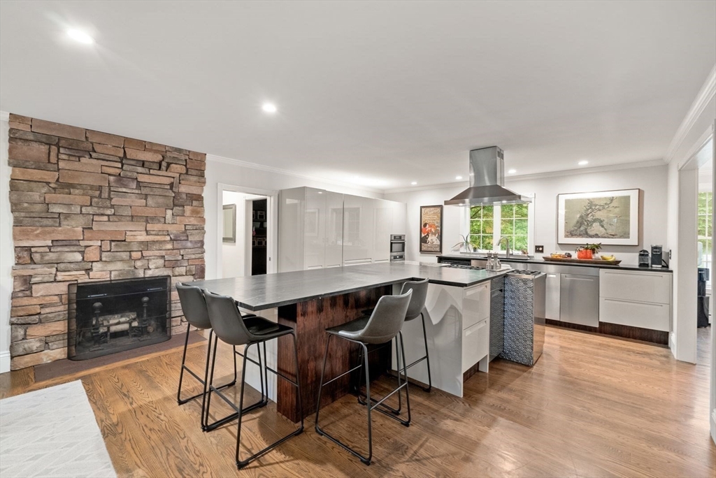 176 Spring Street Hopkinton, MA 01748 - Photo 7 of 42 a kitchen with a table chairs sink and cabinets