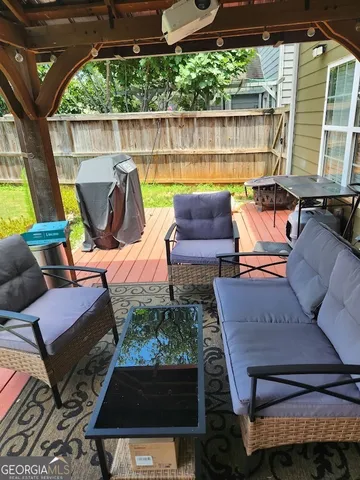 a view of a patio with couches chairs and a wooden floor
