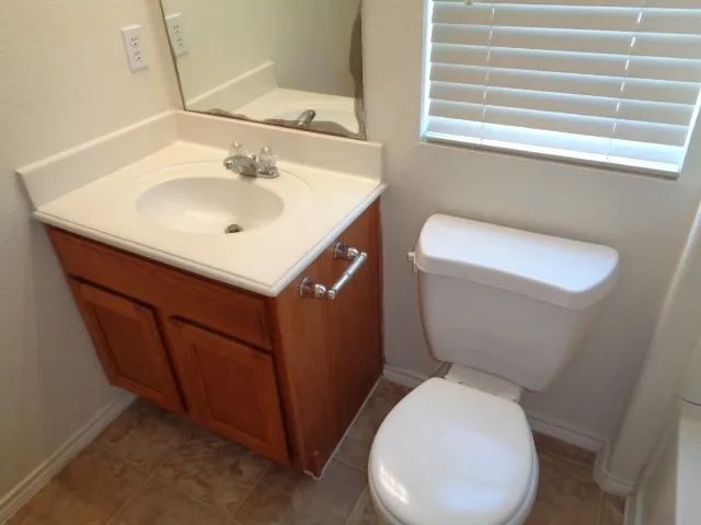 a white toilet sitting next to a bathroom sink