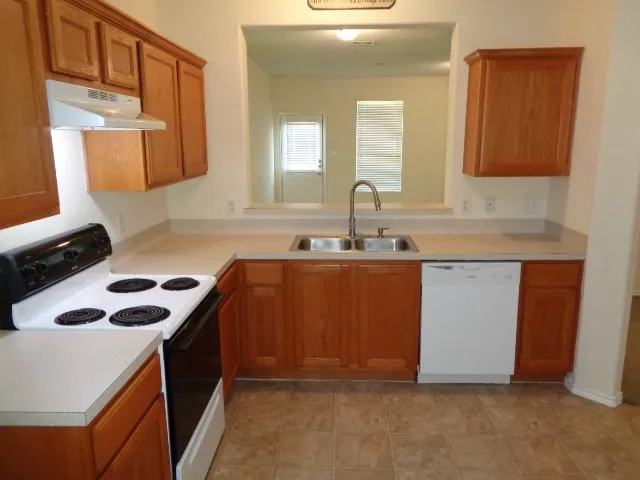 a kitchen with a sink stove and cabinets