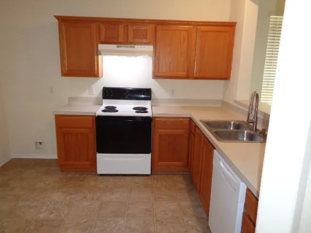 a kitchen with a sink and a stove