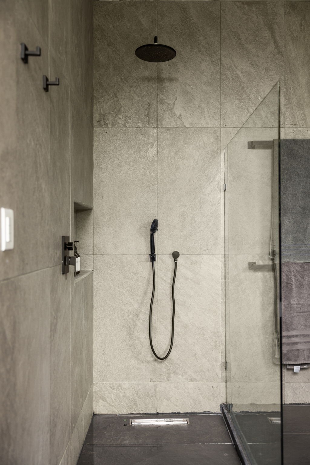 6 Country Club, Unit 4 Nome, TX 77629 - Photo 31 of 45 This minimalist, spa-like walk-in shower exemplifies contemporary luxury with its clean architectural lines and premium organic finishes.