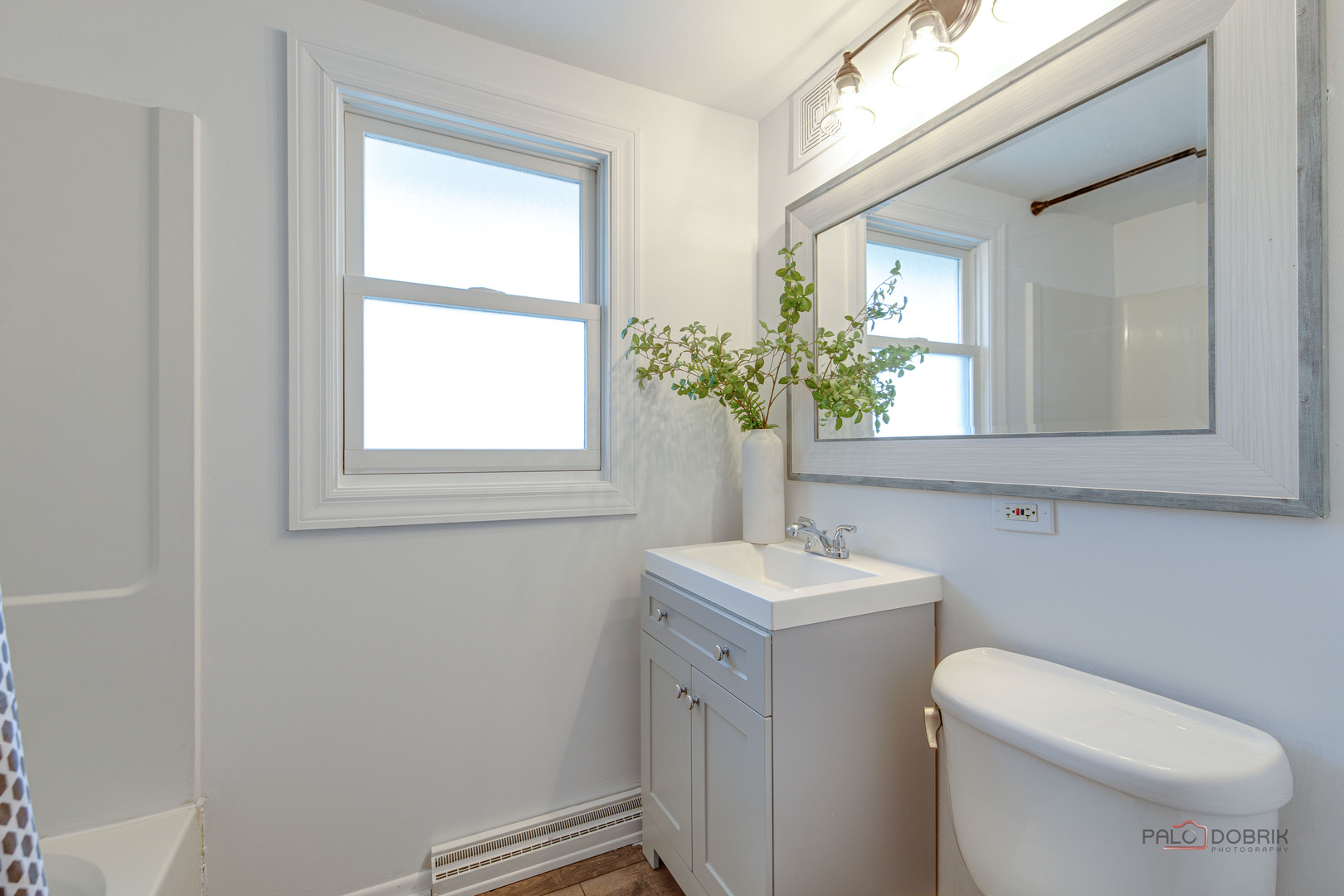 73 South Beck Road Lindenhurst, IL 60046 - Photo 13 of 23 a bathroom with a toilet sink and mirror