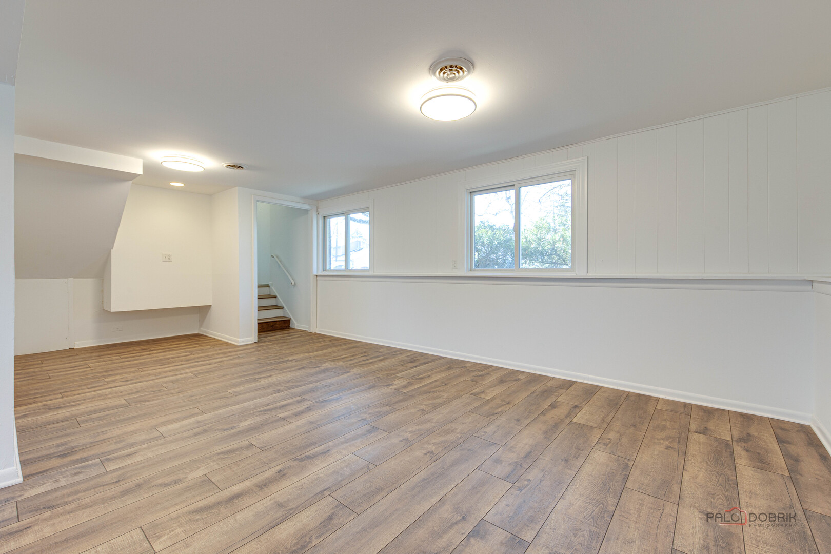 73 South Beck Road Lindenhurst, IL 60046 - Photo 16 of 23 an empty room with wooden floor and windows