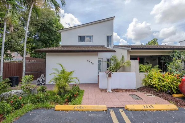 a front view of house with yard and outdoor seating