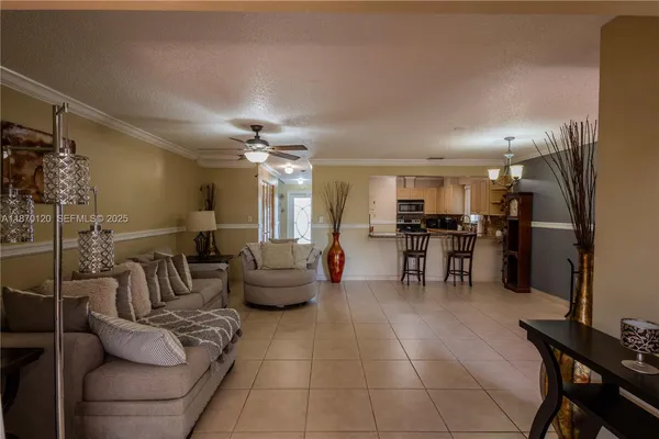 a living room with furniture and kitchen view