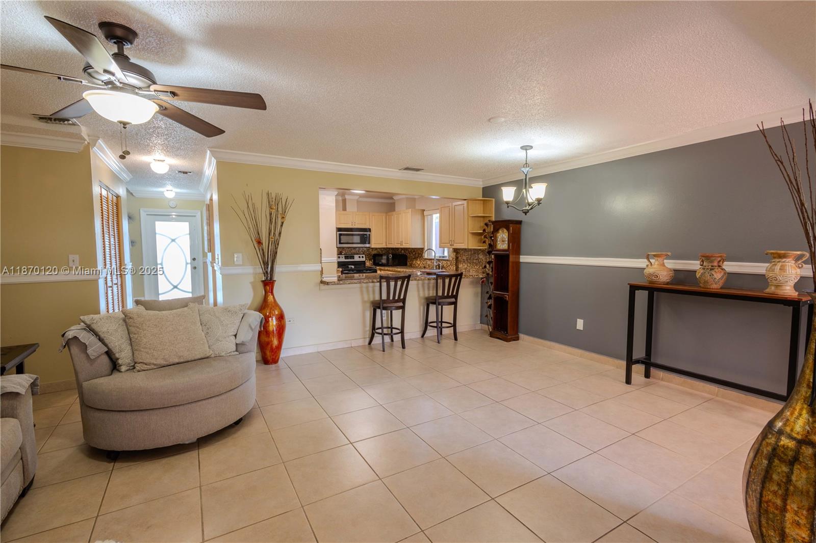 2435 Southwest 11th Street, Unit 9B Miami, FL 33135 - Photo 14 of 33 a living room with furniture and a chandelier