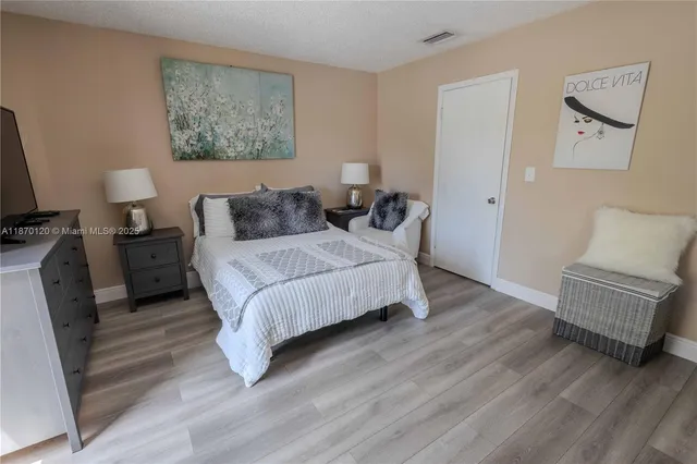 a spacious bedroom with a bed and a couch