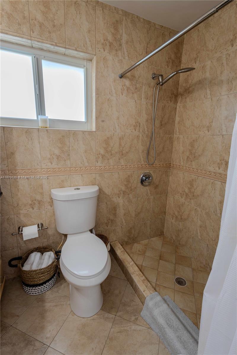 2435 Southwest 11th Street, Unit 9B Miami, FL 33135 - Photo 24 of 33 a bathroom with a toilet and a shower