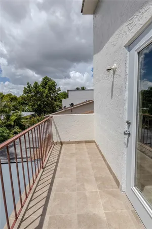 a view of balcony with wooden floor