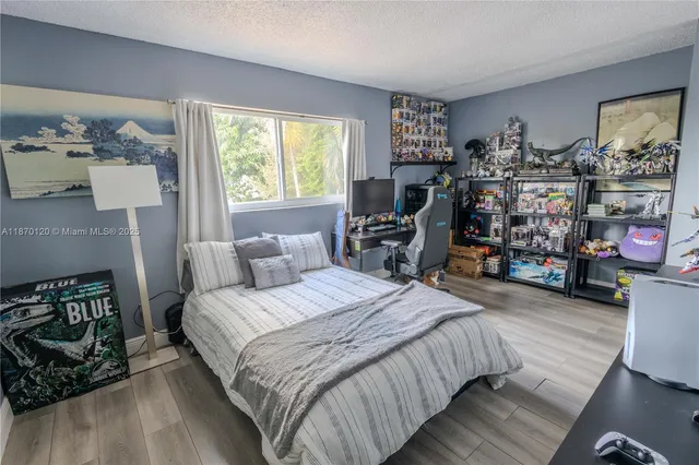 a bedroom with bed a dresser and a window