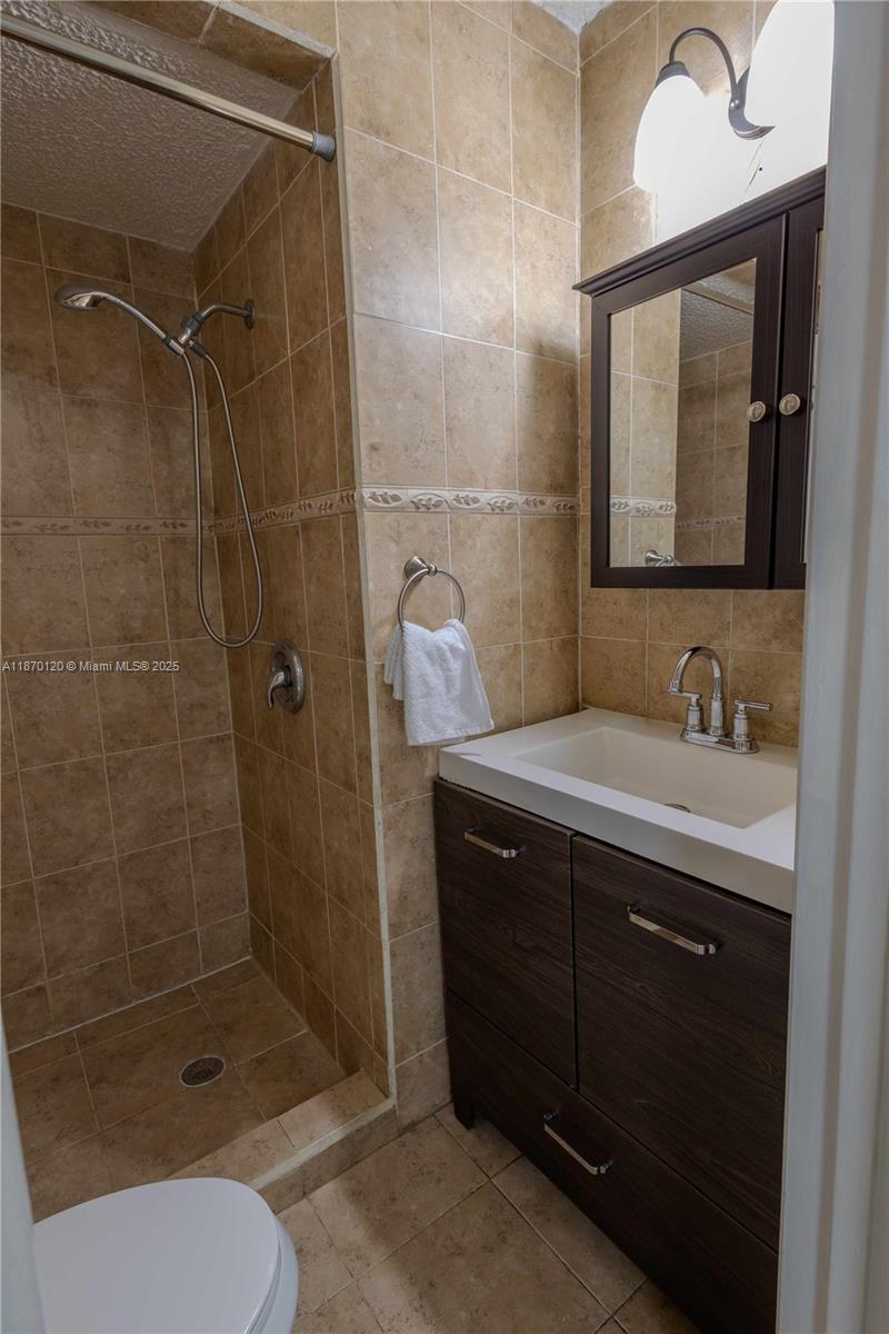 2435 Southwest 11th Street, Unit 9B Miami, FL 33135 - Photo 7 of 33 a bathroom with a sink toilet and shower