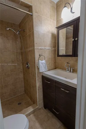a bathroom with a sink toilet and shower