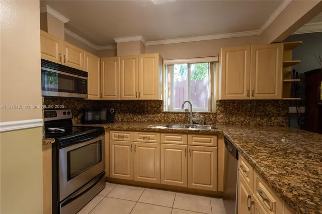 a kitchen with a sink stove and microwave