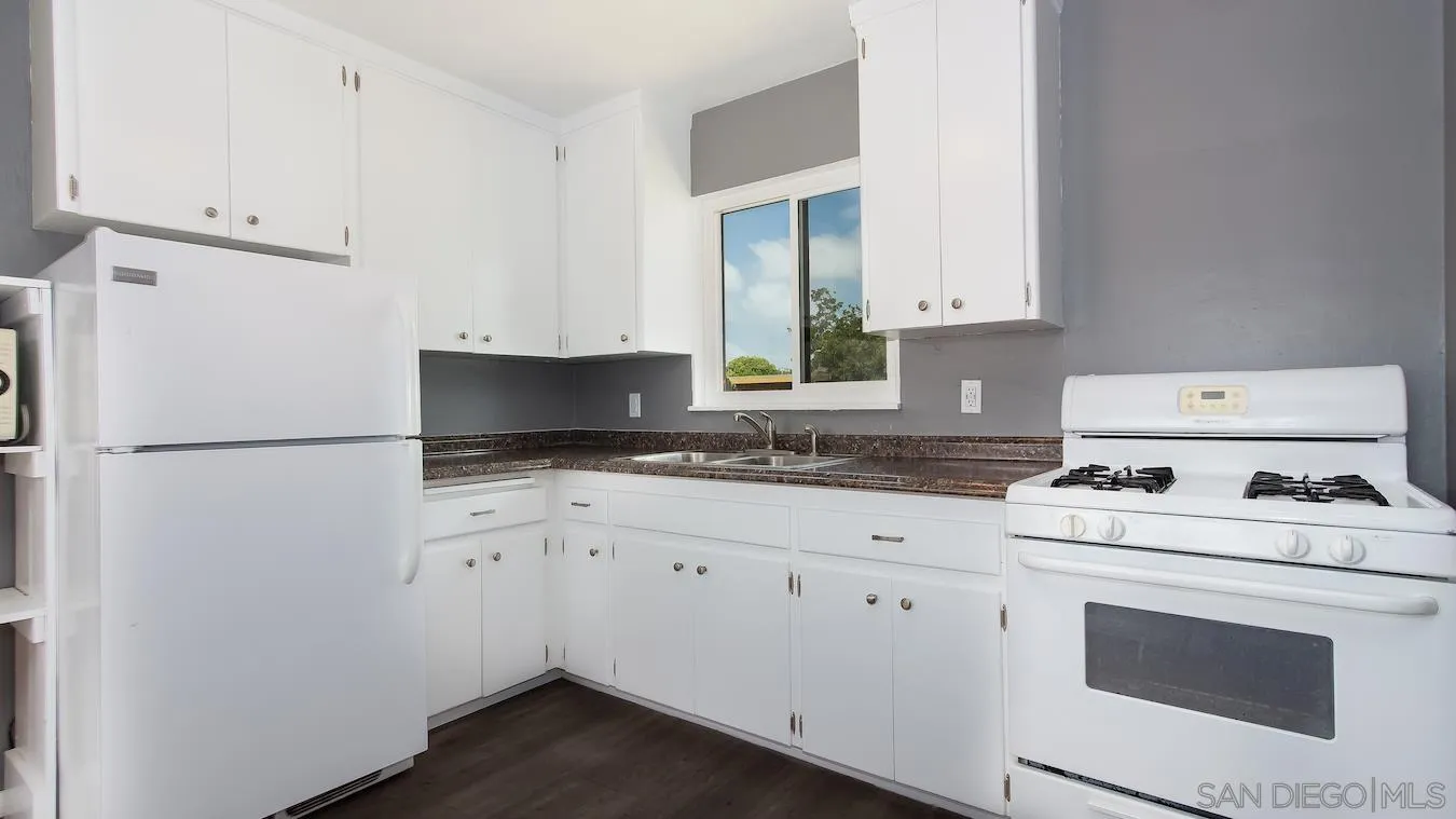 238 E Street Chula Vista, CA 91910 - Photo 4 of 15 a kitchen with appliances a sink and cabinets