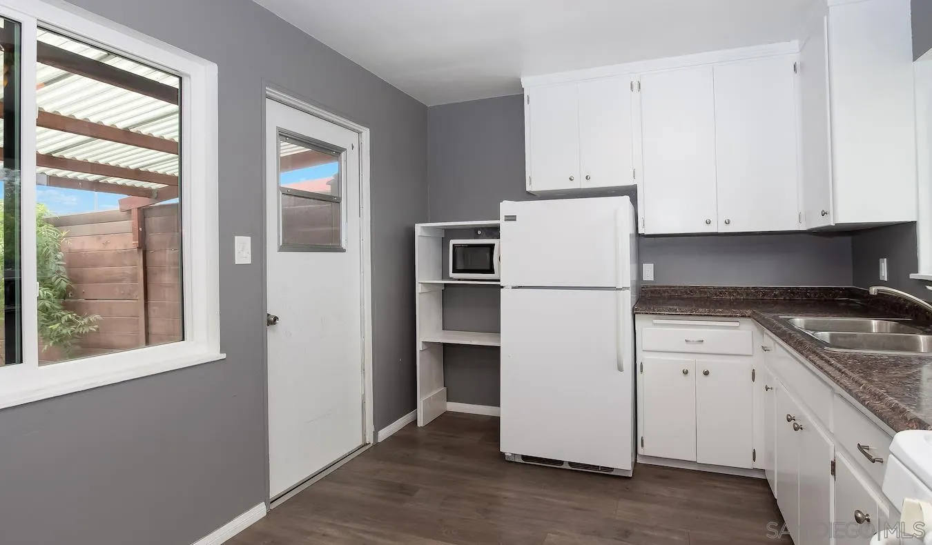 238 E Street Chula Vista, CA 91910 - Photo 5 of 15 a white refrigerator freezer sitting inside of a kitchen