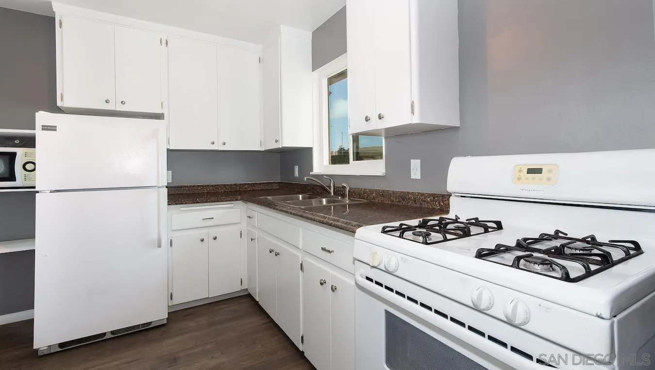238 E Street Chula Vista, CA 91910 - Photo 6 of 15 a kitchen with cabinets appliances a sink and a stove