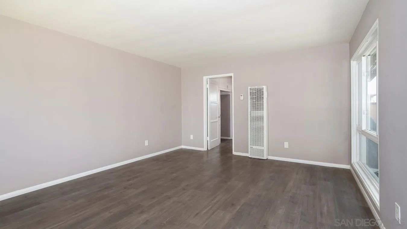 238 E Street Chula Vista, CA 91910 - Photo 7 of 15 an empty room with wooden floor & windows