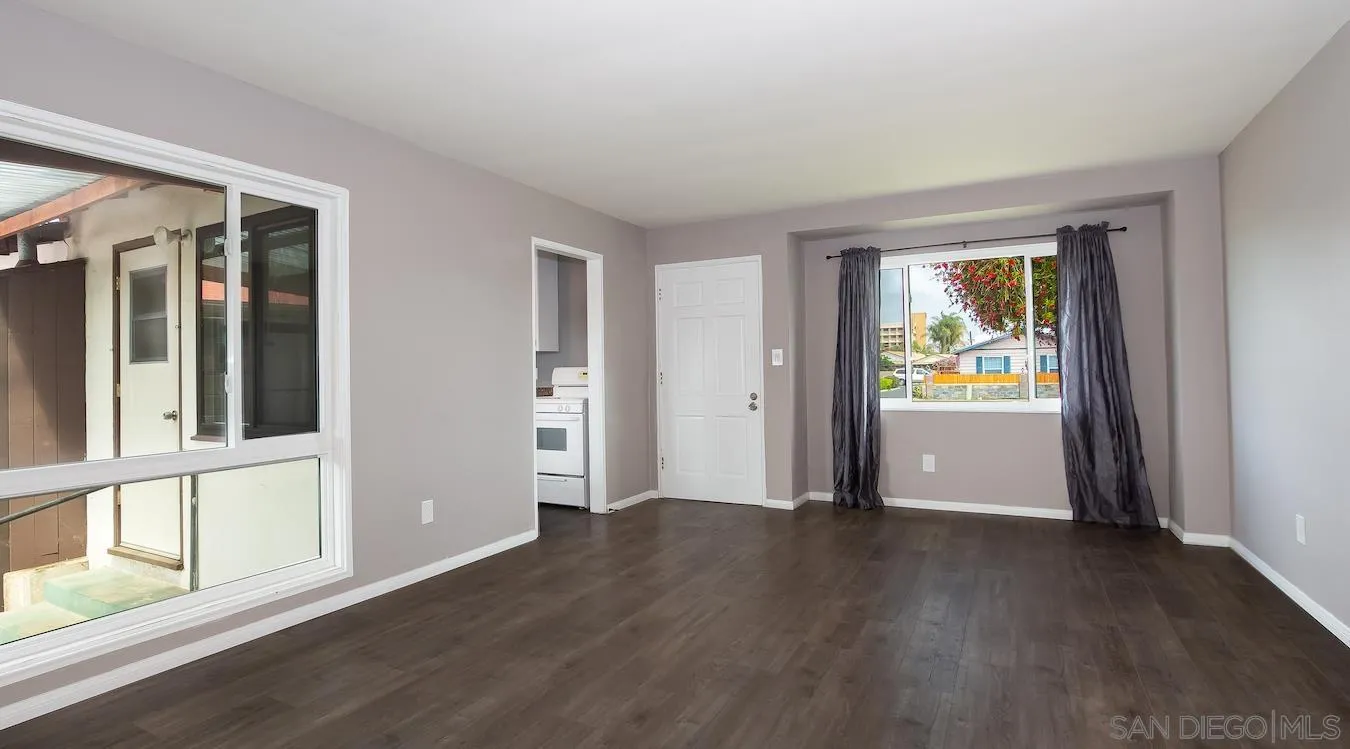 238 E Street Chula Vista, CA 91910 - Photo 9 of 15 an empty room with wooden floor and windows