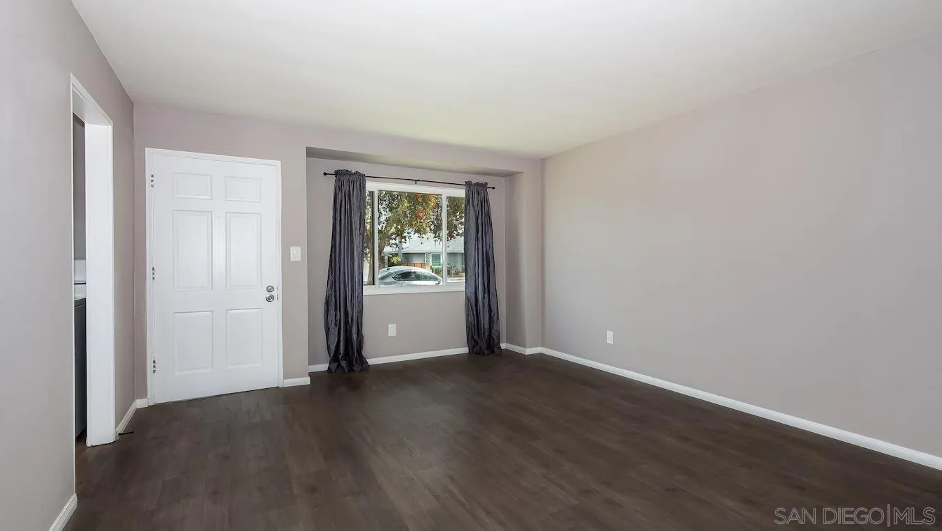 238 E Street Chula Vista, CA 91910 - Photo 10 of 15 an empty room with wooden floor and a window