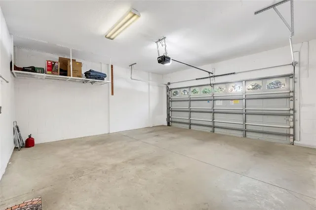 en empty room with ceiling fan and windows