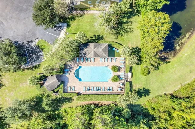 a view of swimming pool with seating area and green space