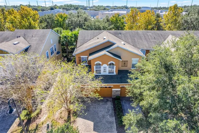an aerial view of a house with a yard