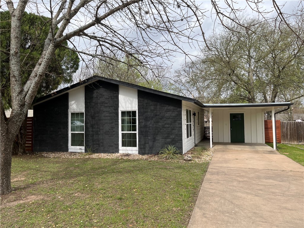 a house that has a tree in front of the house