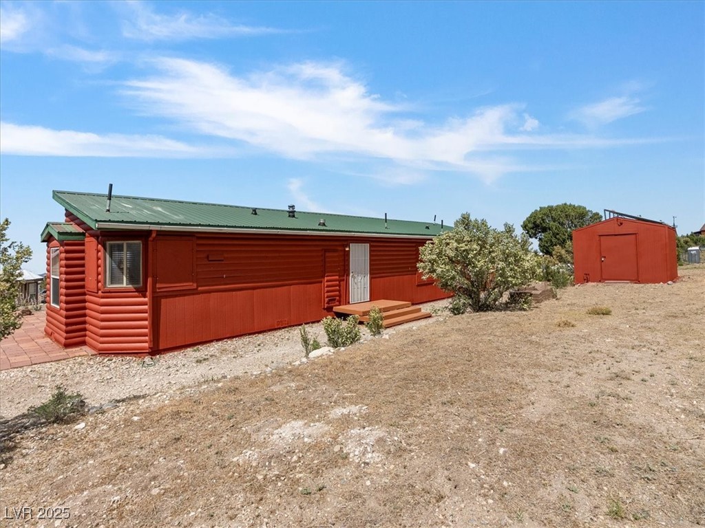 70 West Bonanza Road Las Vegas, NV 89124 - Photo 44 of 71 Back of property with log veneer siding and metal roof