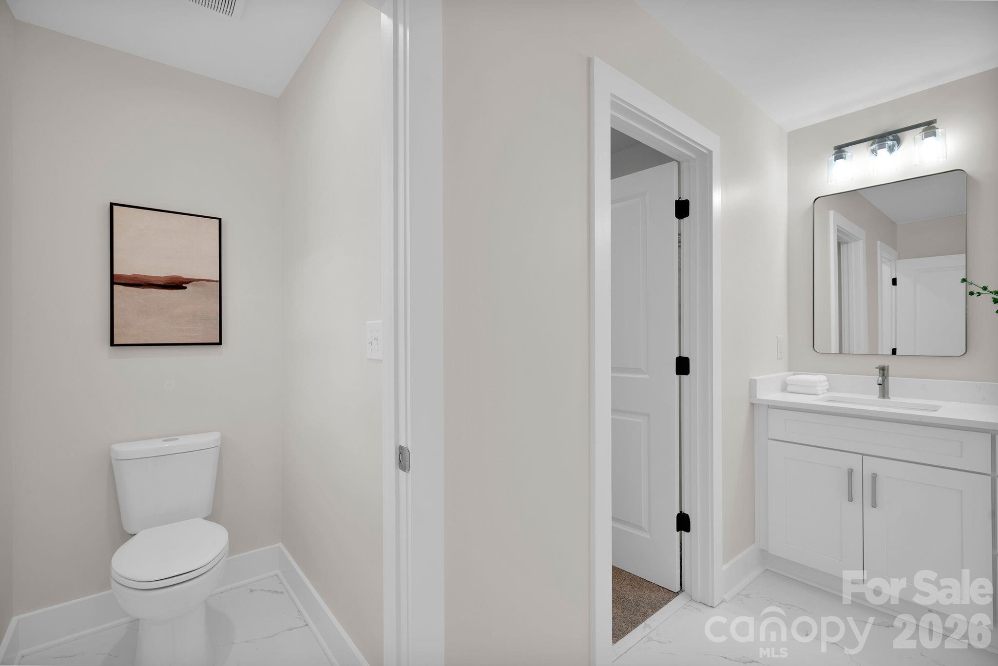 9022 Unity Church Road Mooresville, NC 28115 - Photo 19 of 22 a bathroom with a toilet a sink and mirror