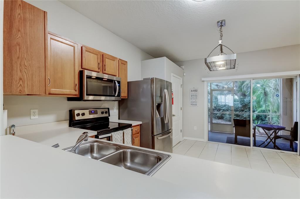 1138 Hillhurst Drive Wesley Chapel, FL 33543 - Photo 14 of 65 a kitchen with stainless steel appliances a refrigerator stove microwave and sink