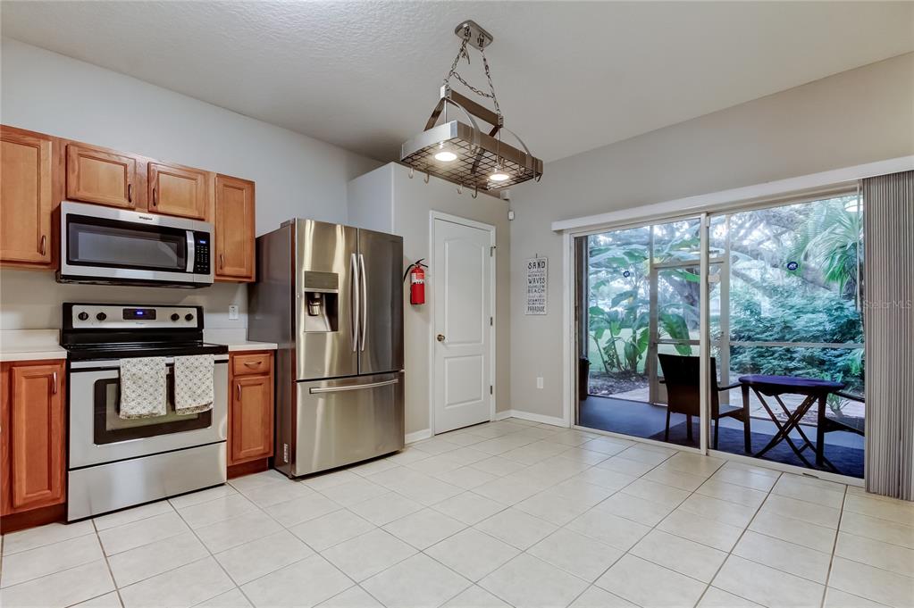 1138 Hillhurst Drive Wesley Chapel, FL 33543 - Photo 15 of 65 a kitchen with stainless steel appliances granite countertop a refrigerator microwave and stove top oven