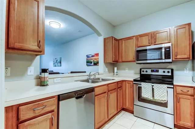 a kitchen with stainless steel appliances a refrigerator microwave and sink
