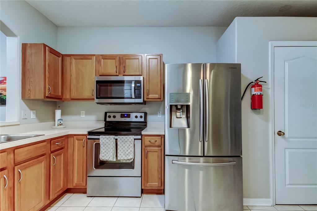 1138 Hillhurst Drive Wesley Chapel, FL 33543 - Photo 17 of 65 a kitchen with stainless steel appliances granite countertop a refrigerator and a stove top oven
