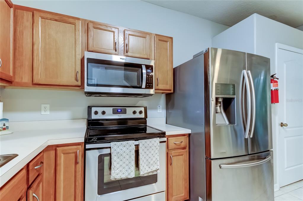 1138 Hillhurst Drive Wesley Chapel, FL 33543 - Photo 19 of 65 a kitchen with stainless steel appliances a refrigerator microwave and sink