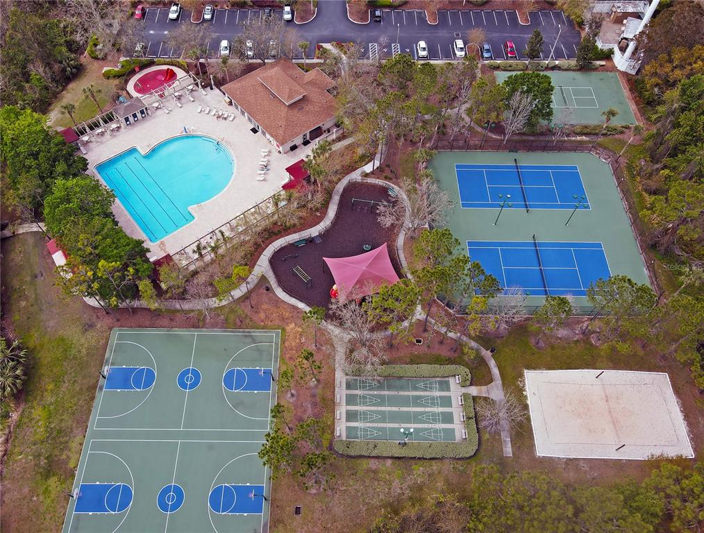 1138 Hillhurst Drive Wesley Chapel, FL 33543 - Photo 2 of 65 an aerial view of a pool patio kitchen and outdoor seating